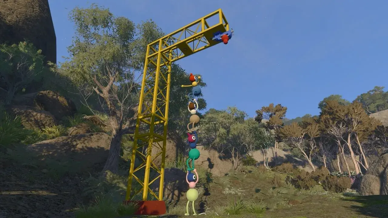 Players stacking into a totem pole to reach a high switch.
